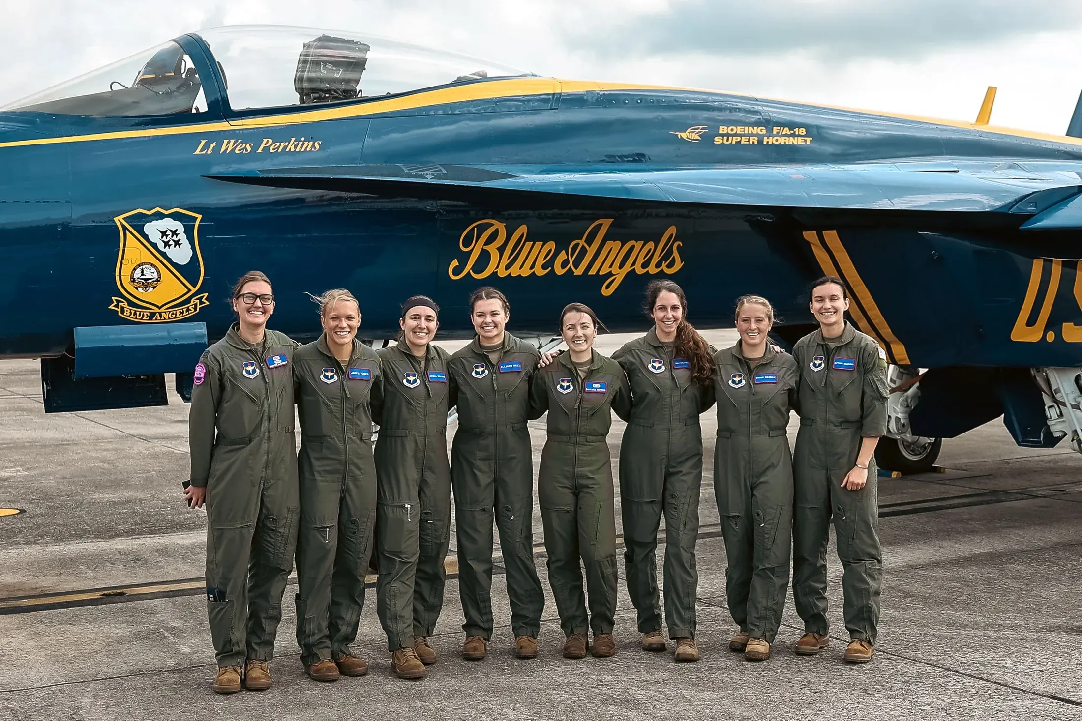 Aviators lined up in front of a Blue Angels jet