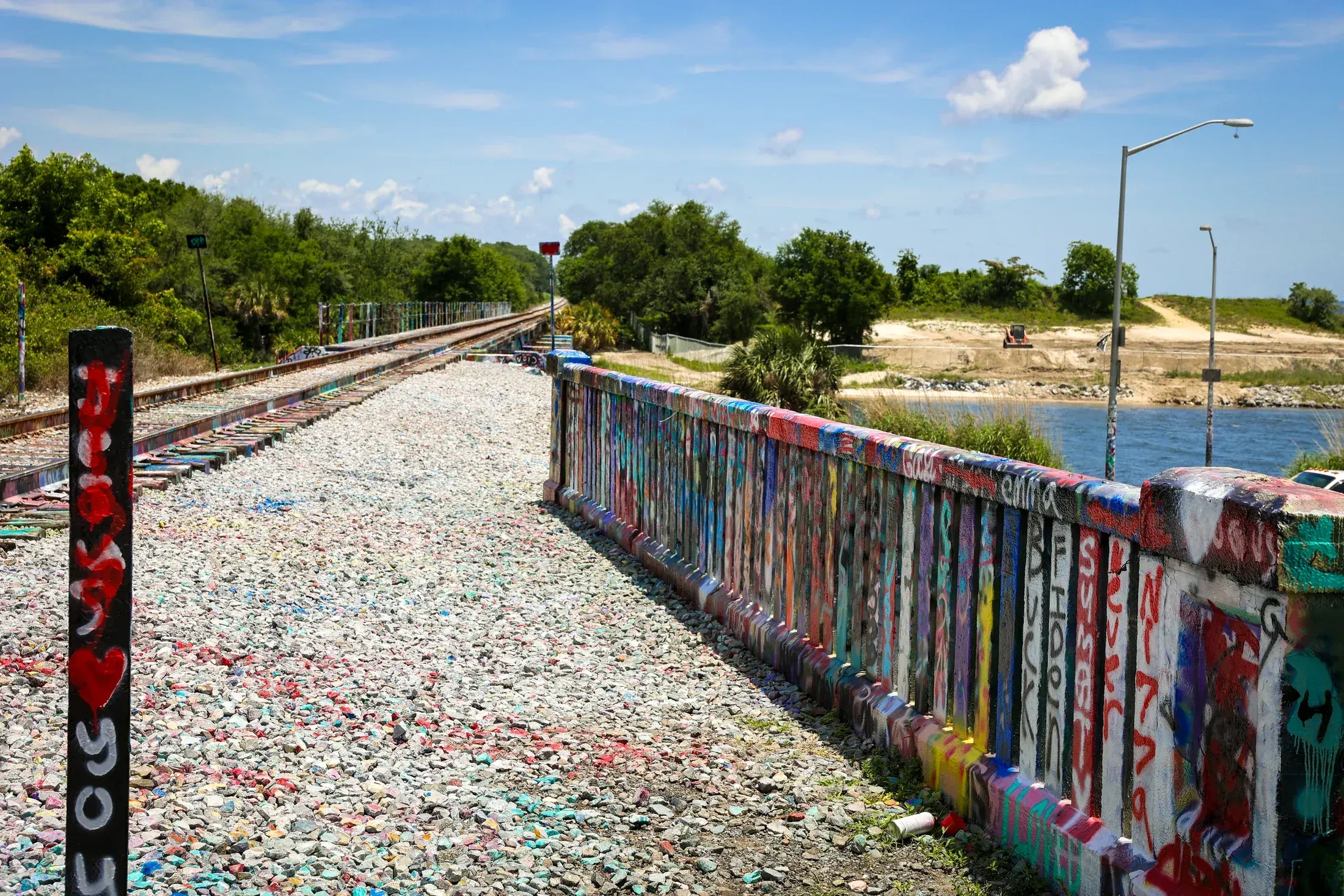 Graffiti covered train trestle over the river