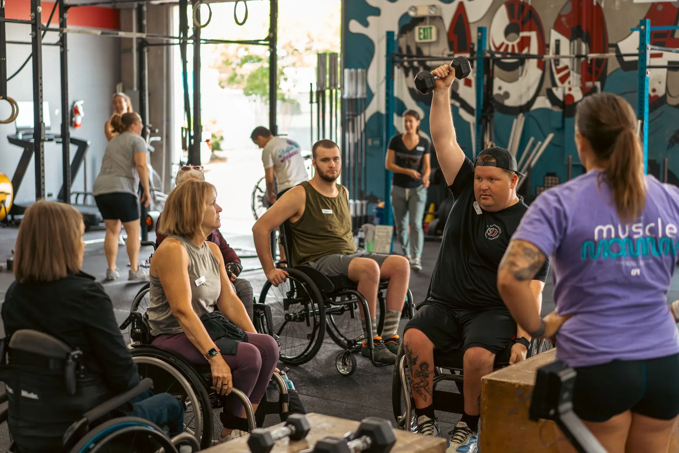 Adaptive athletes circled up for a group class