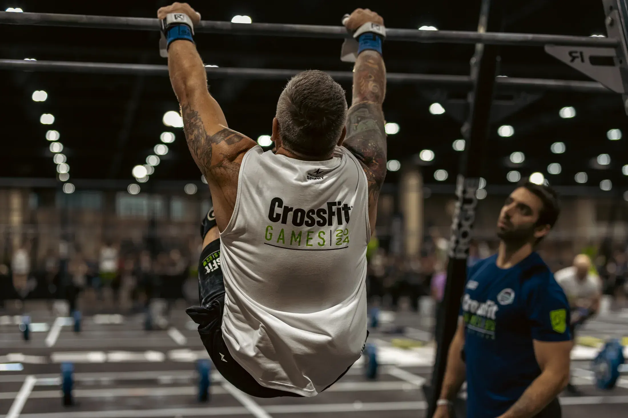 Competitor hanging from the pull up rig at the CrossFit Games