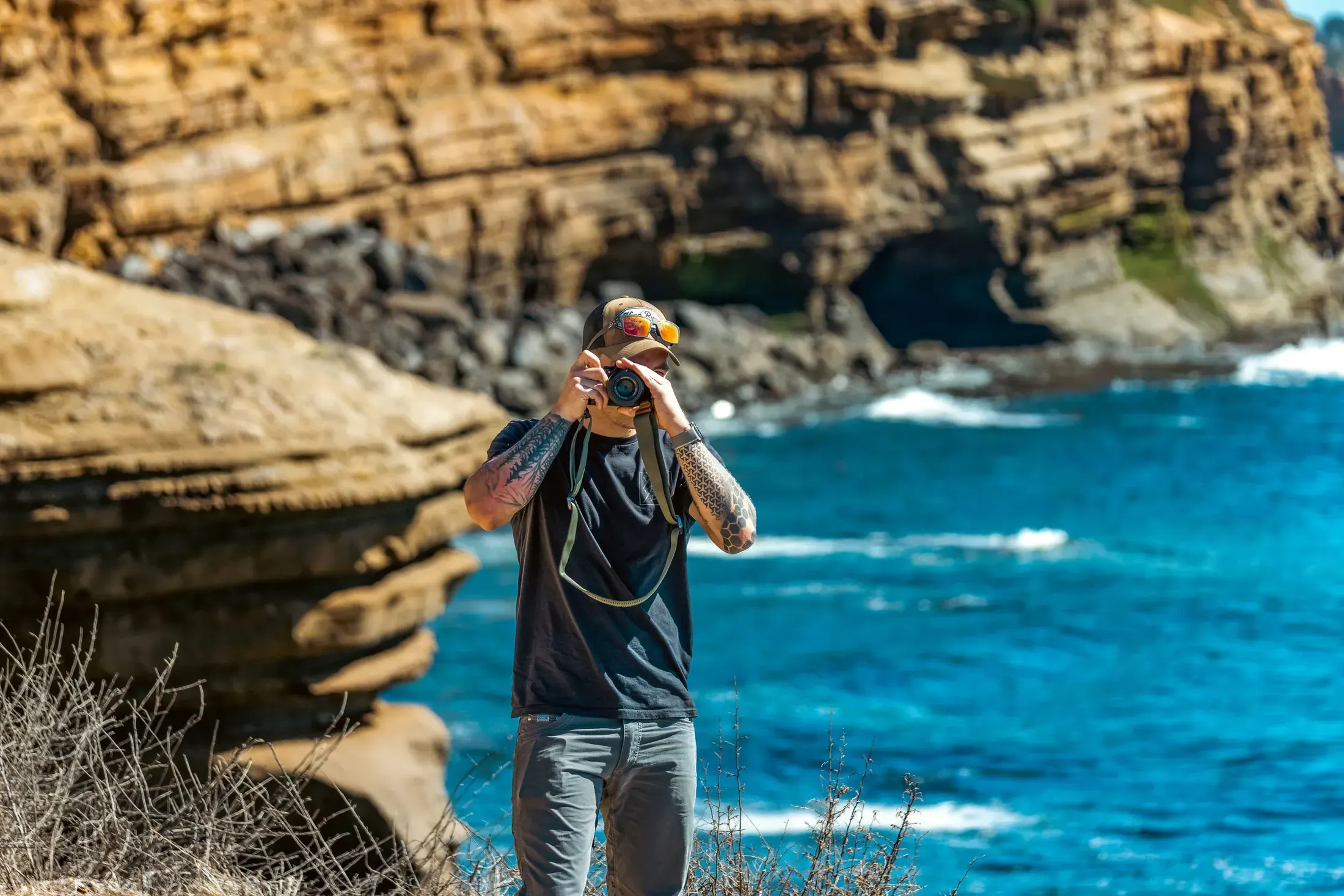 Photographer shooting the sea cliffs above the Pacific