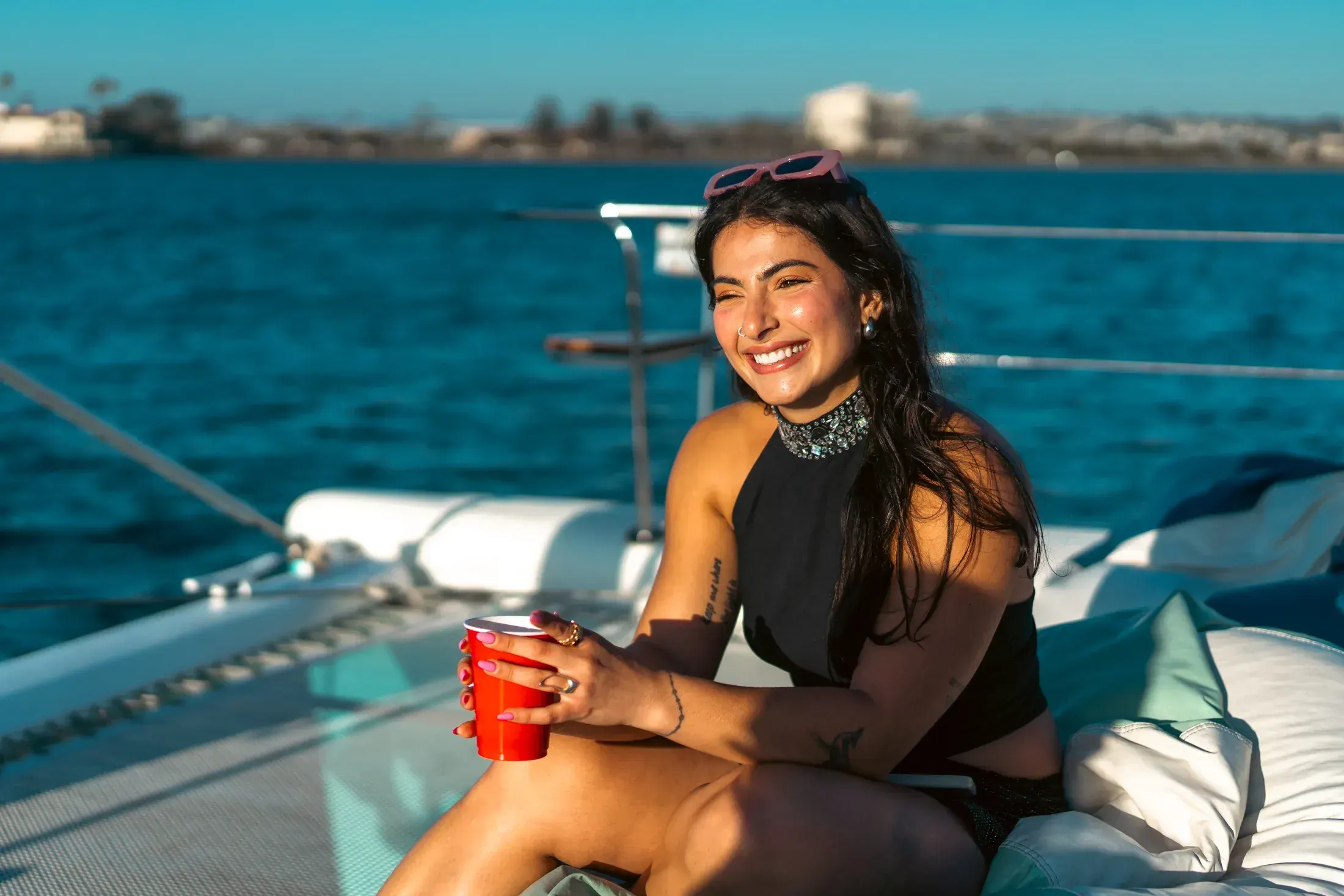 Woman smiling on a catamaran in the bay