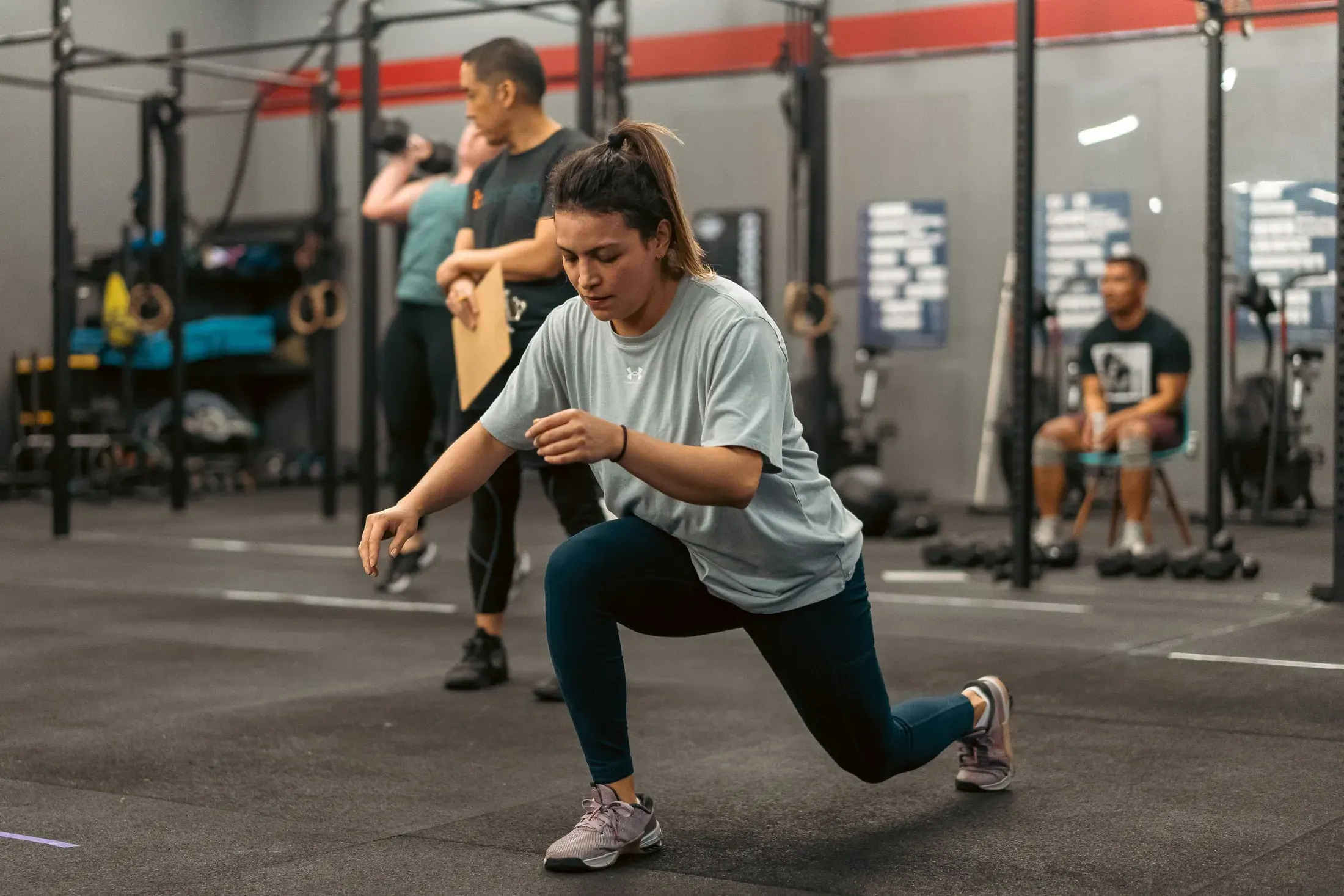 Athlete doing lunges in a group class