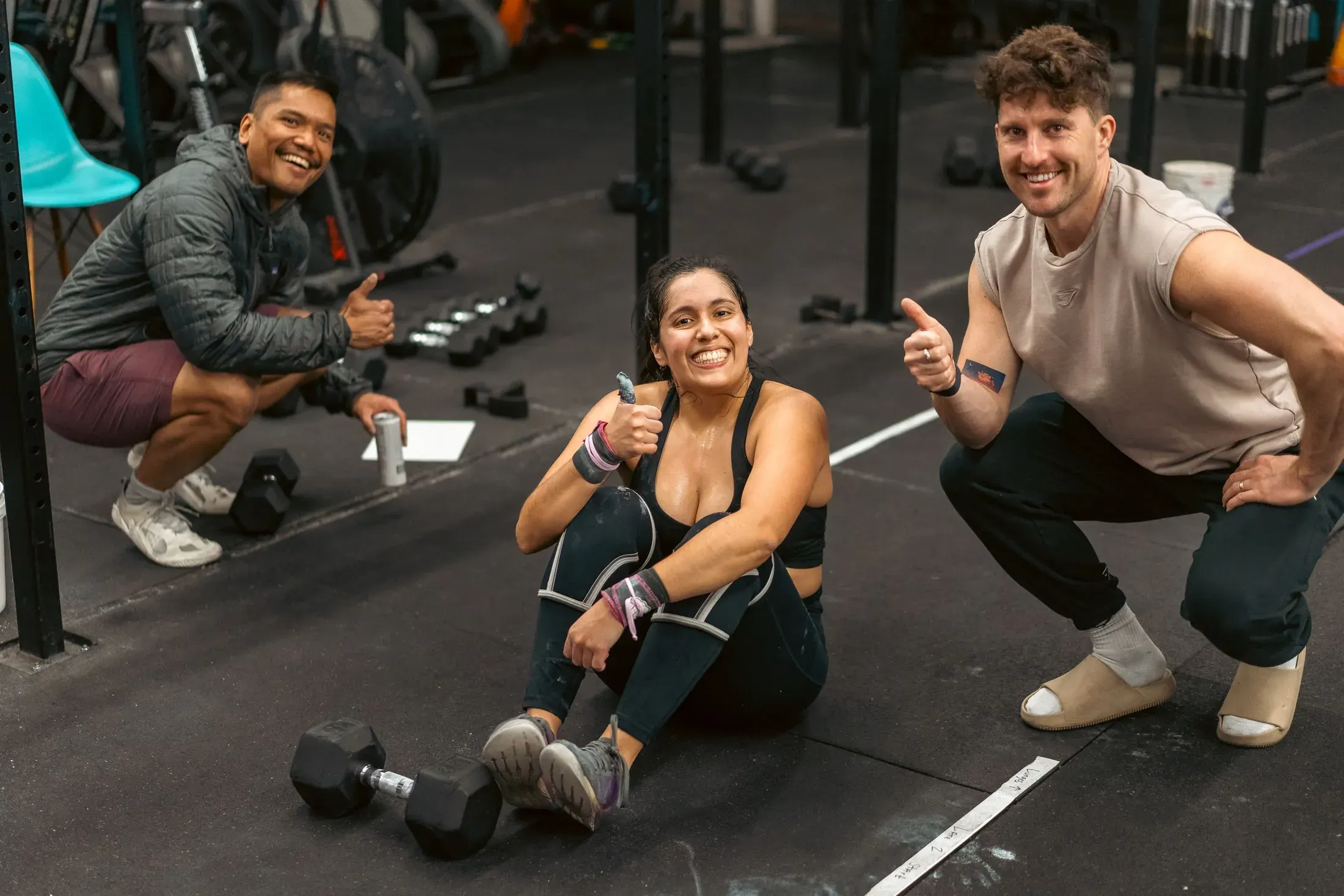 Athletes laughing together on the gym floor