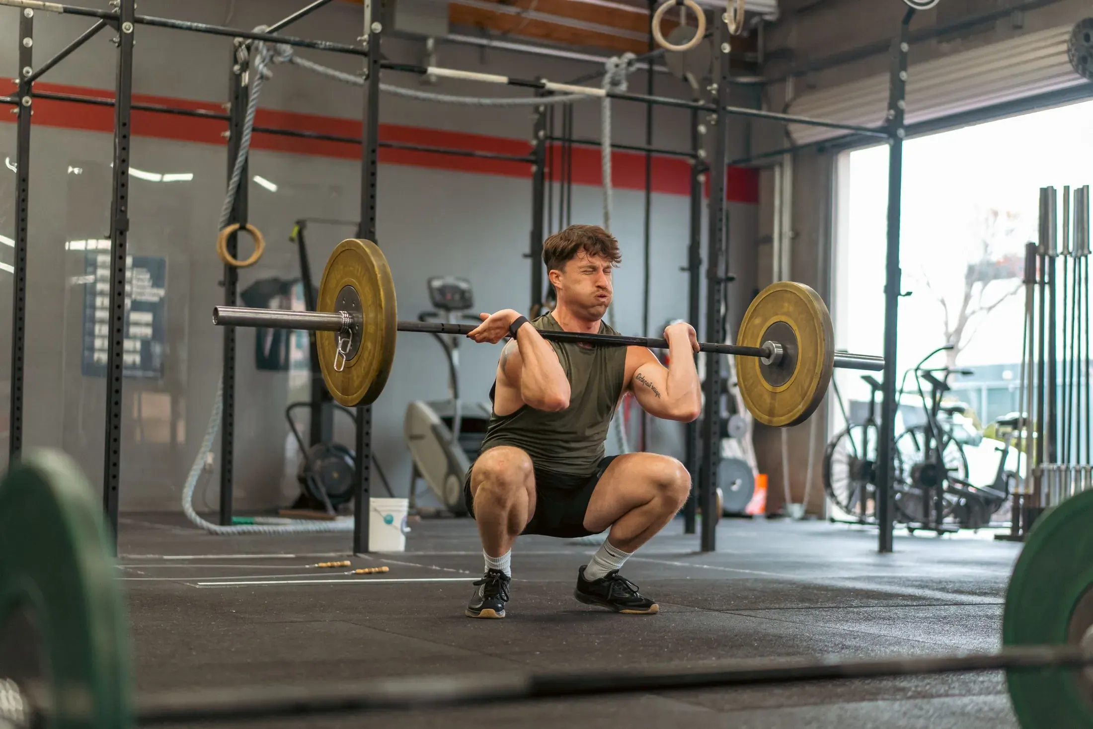 Athlete holding a front squat in a garage gym