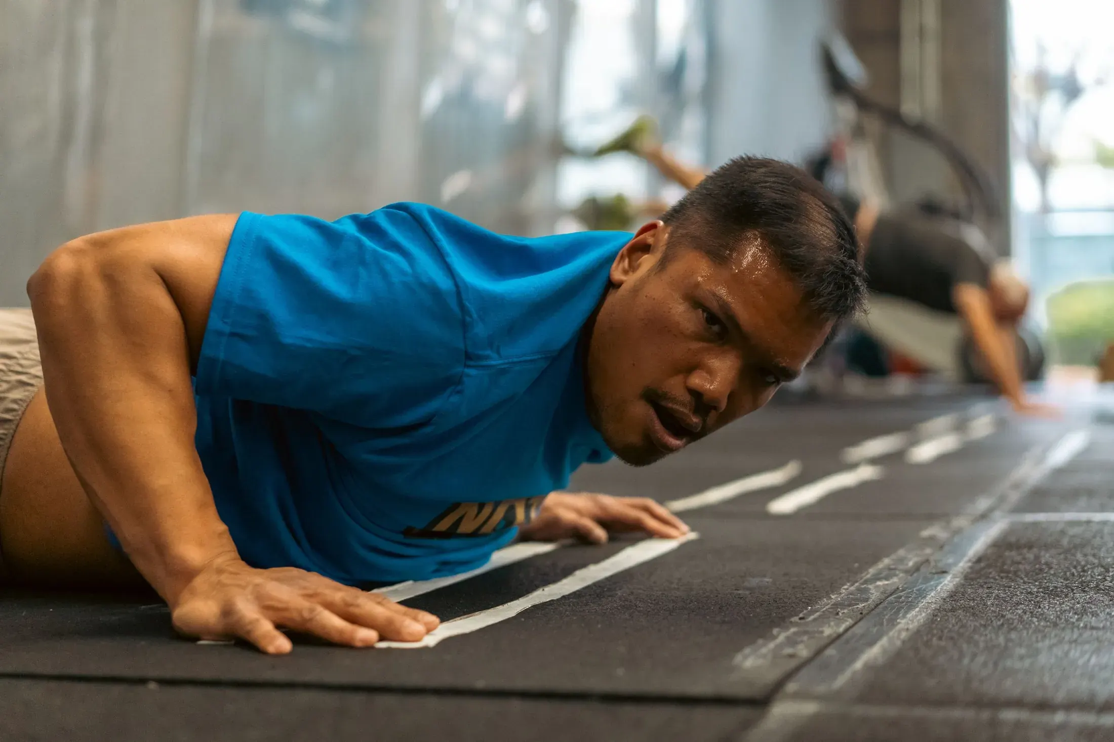Exhausted athlete lying on the floor after a workout