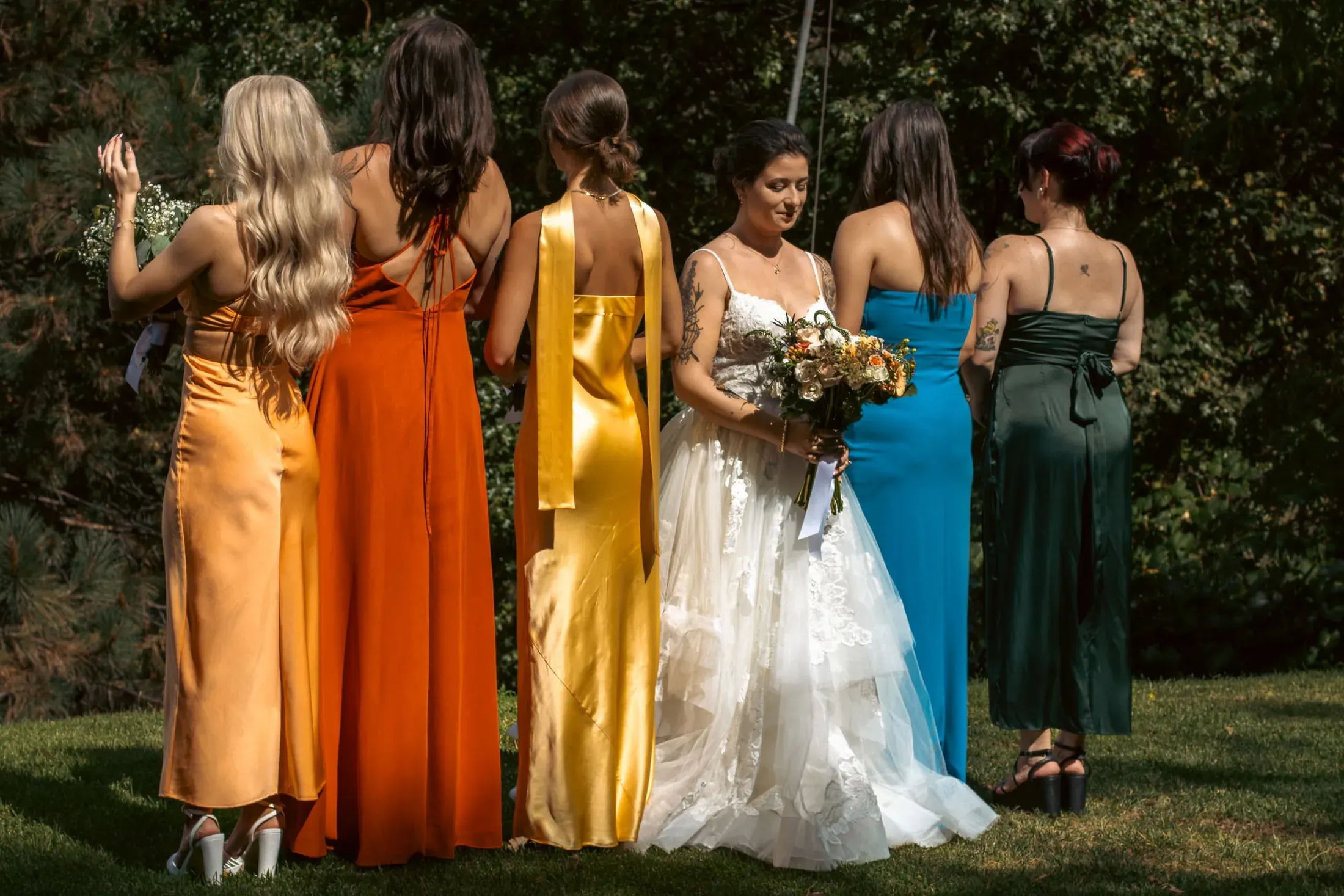 Bride with her bridesmaids in colorful dresses