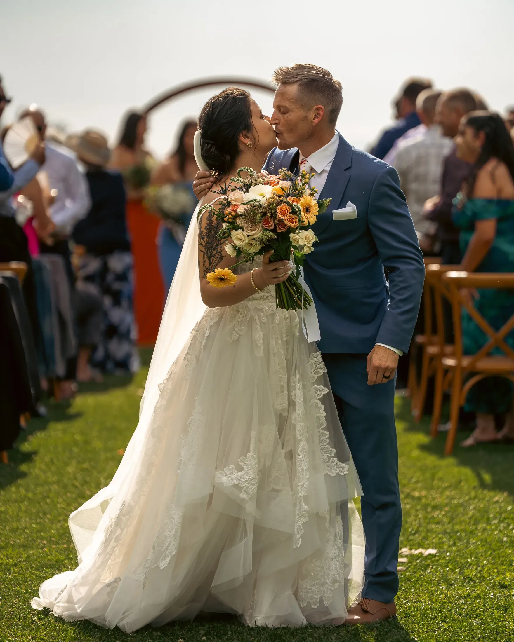 Bride and groom kissing at the altar