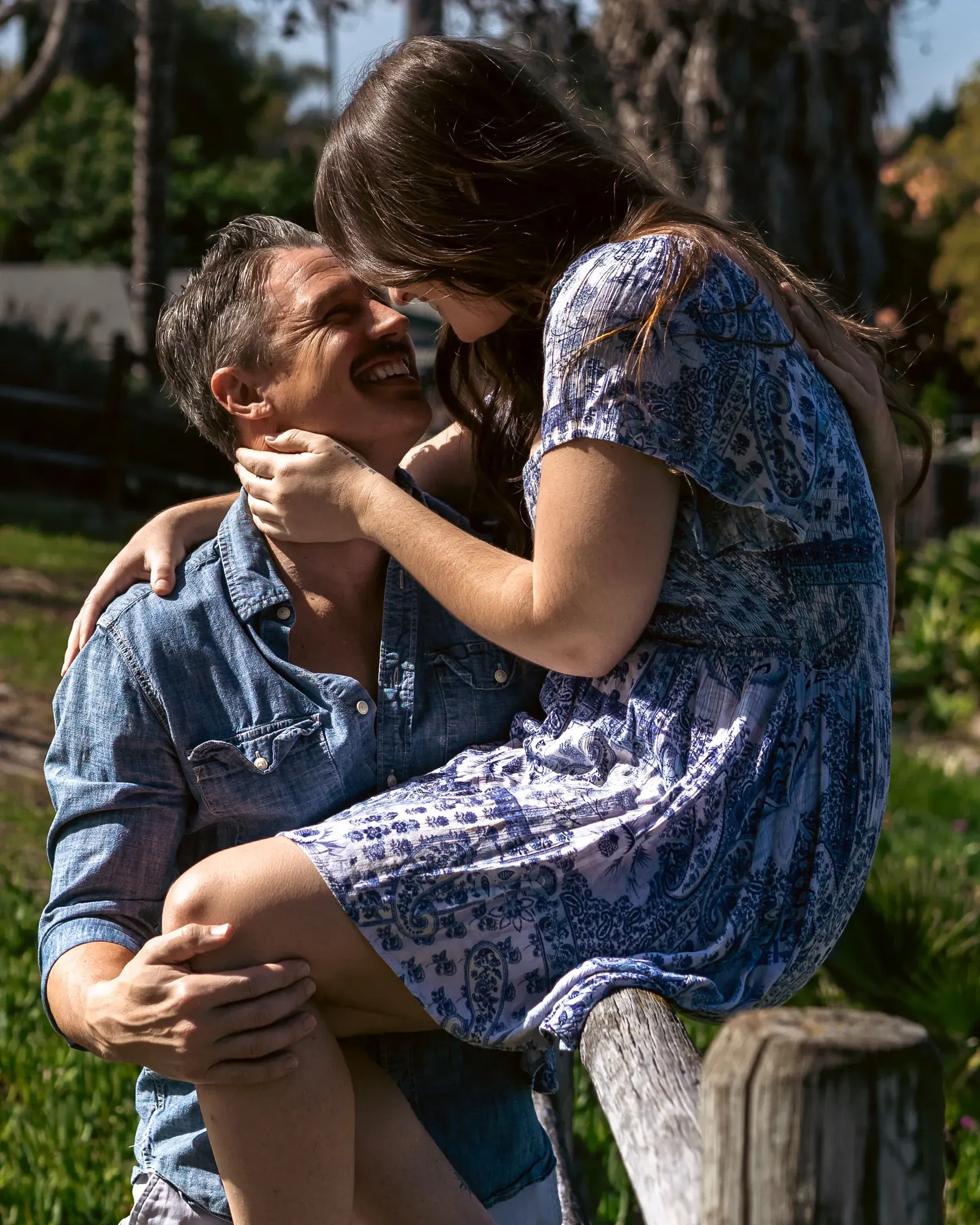 Couple embracing and laughing outdoors