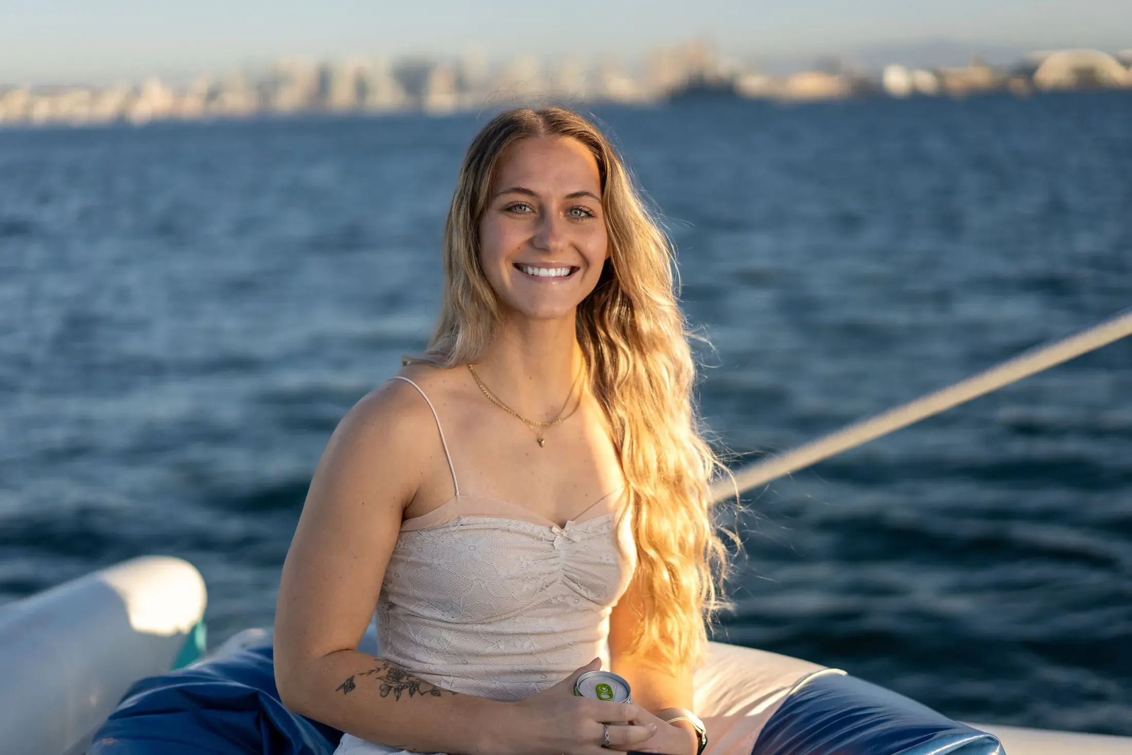 Woman with long hair smiling on a boat on the bay