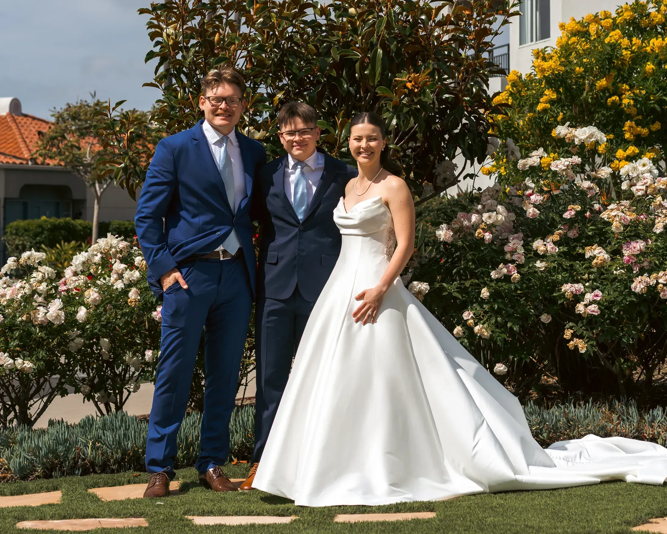 Bride and groom with a friend at the ceremony site
