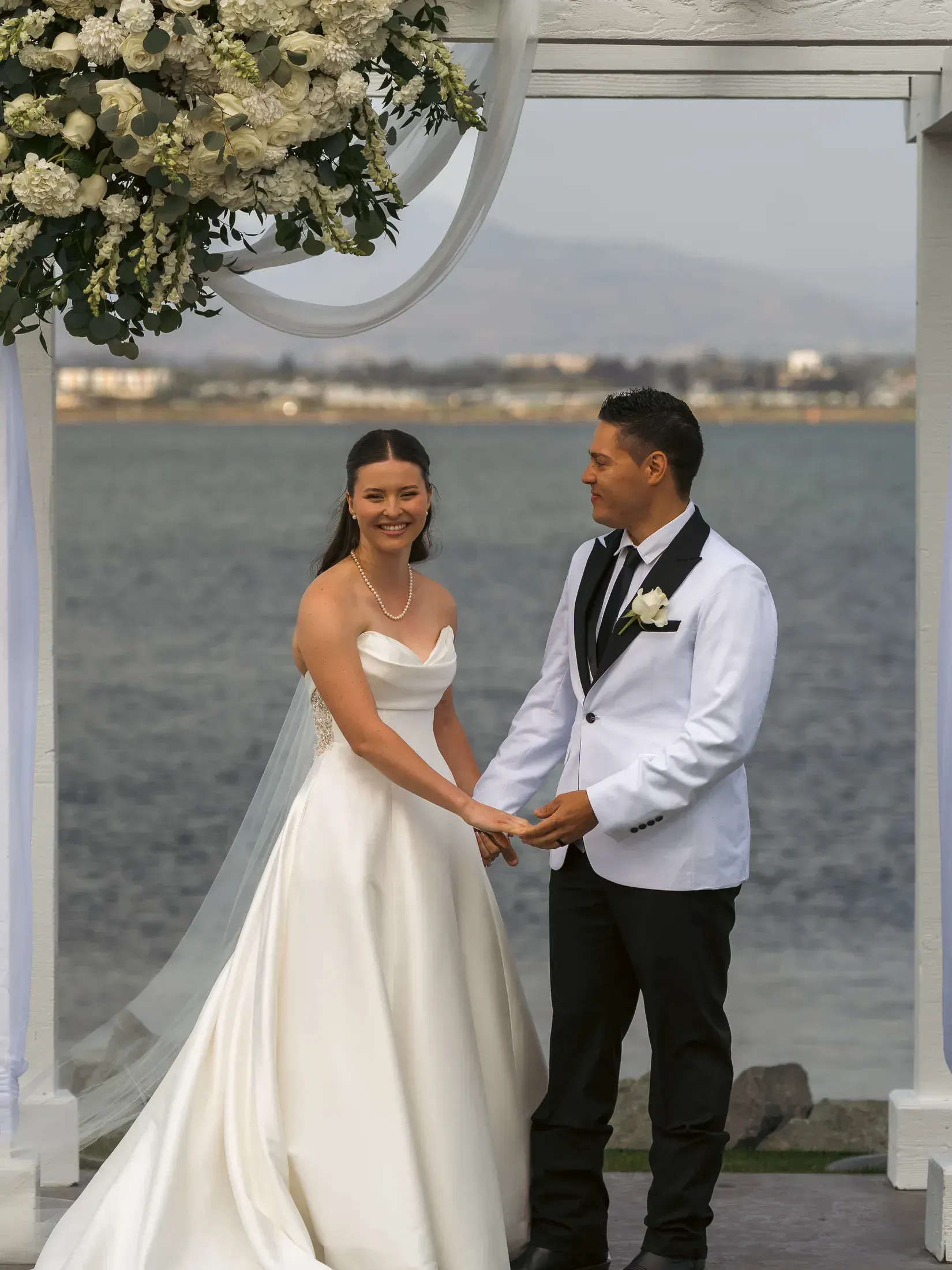 Bride and groom holding hands at the altar