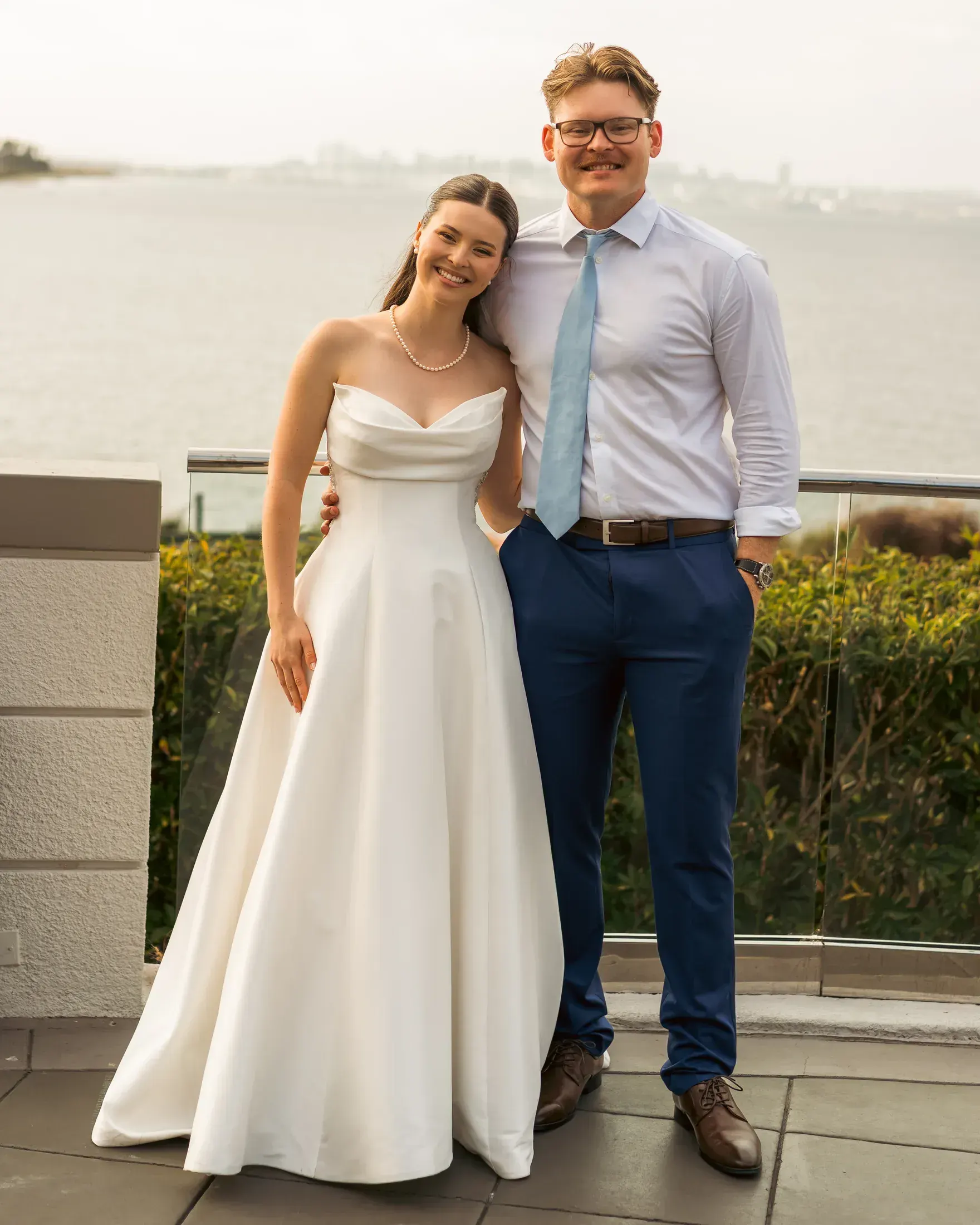 Bride and groom by the water after the ceremony