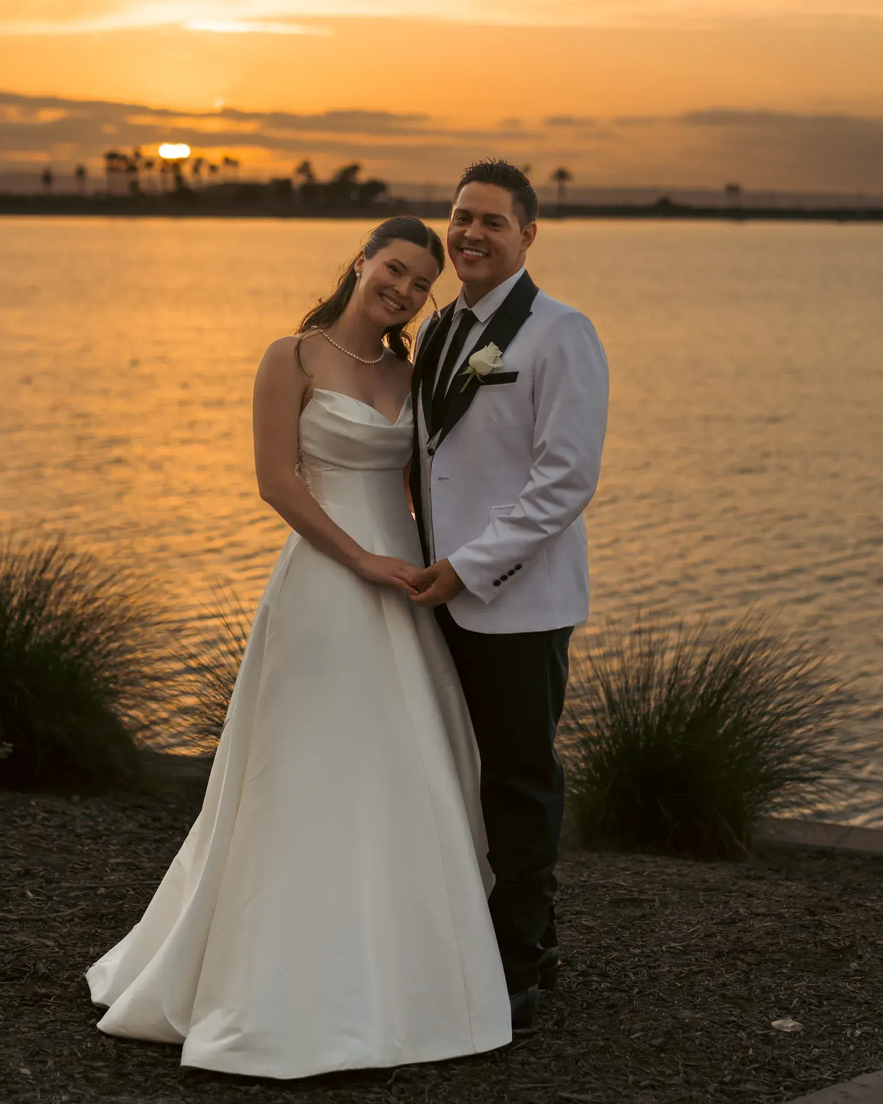 Bride and groom at sunset on the bay