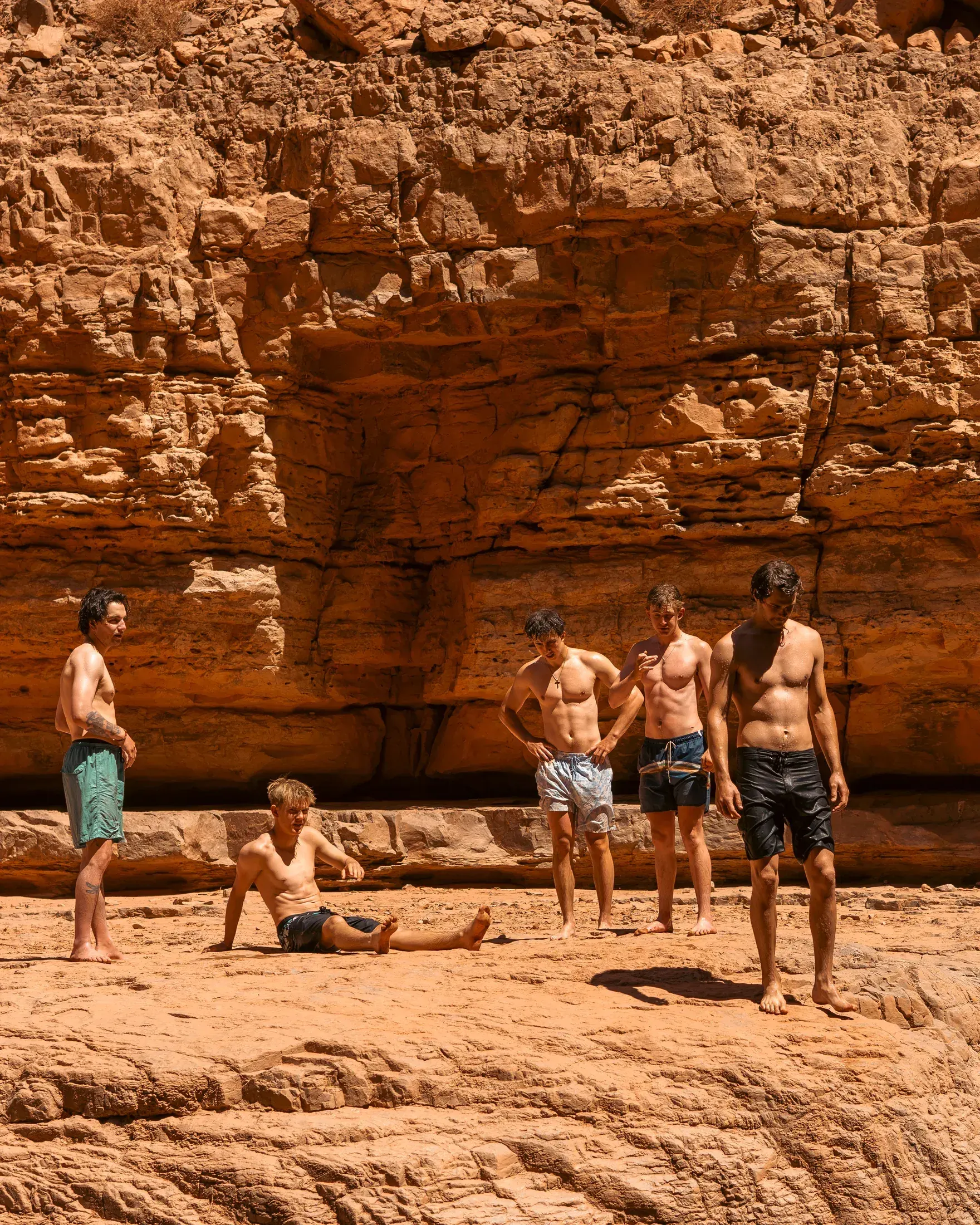 Friends on the sandstone at a desert swimming hole