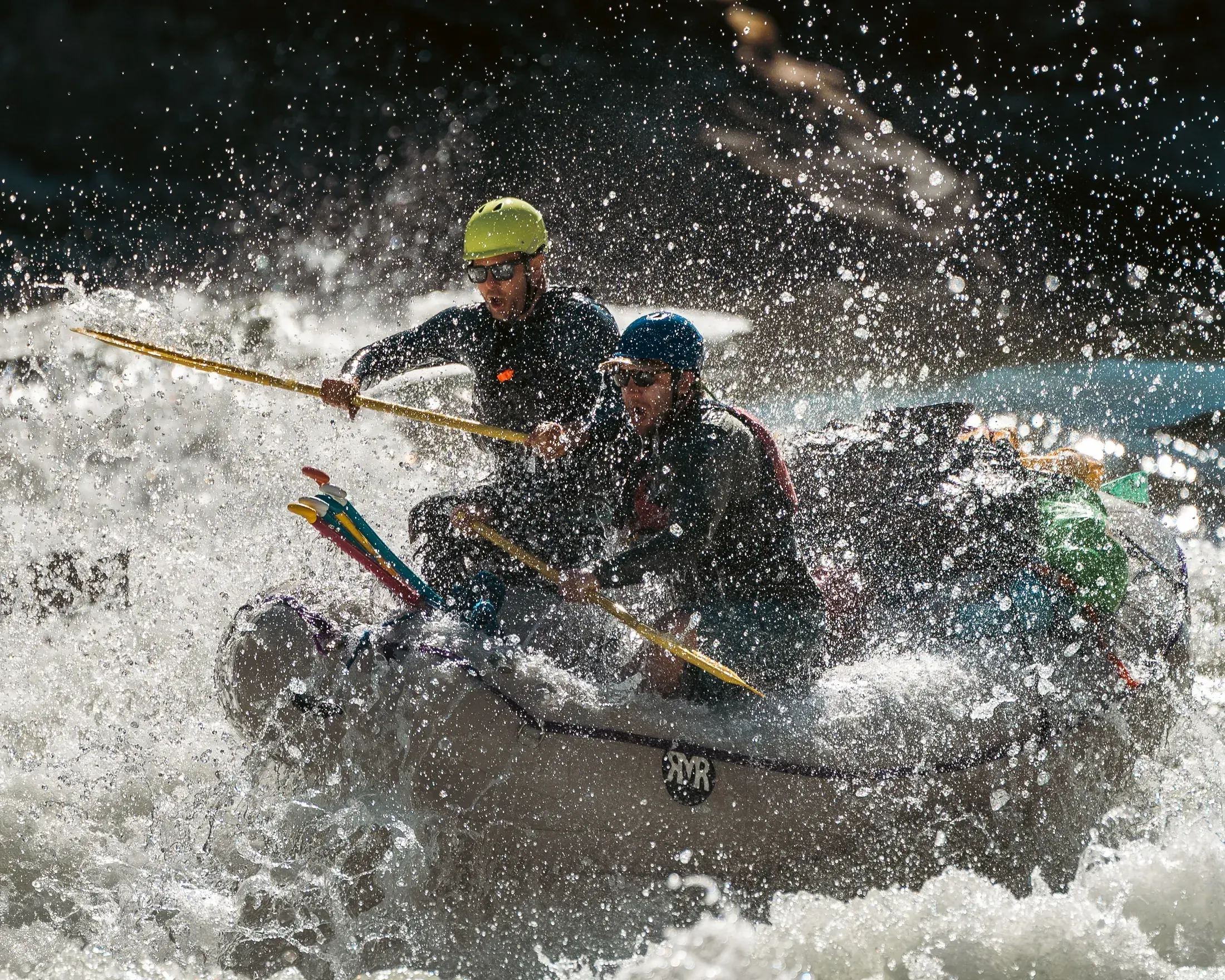 Rafters punching through whitewater
