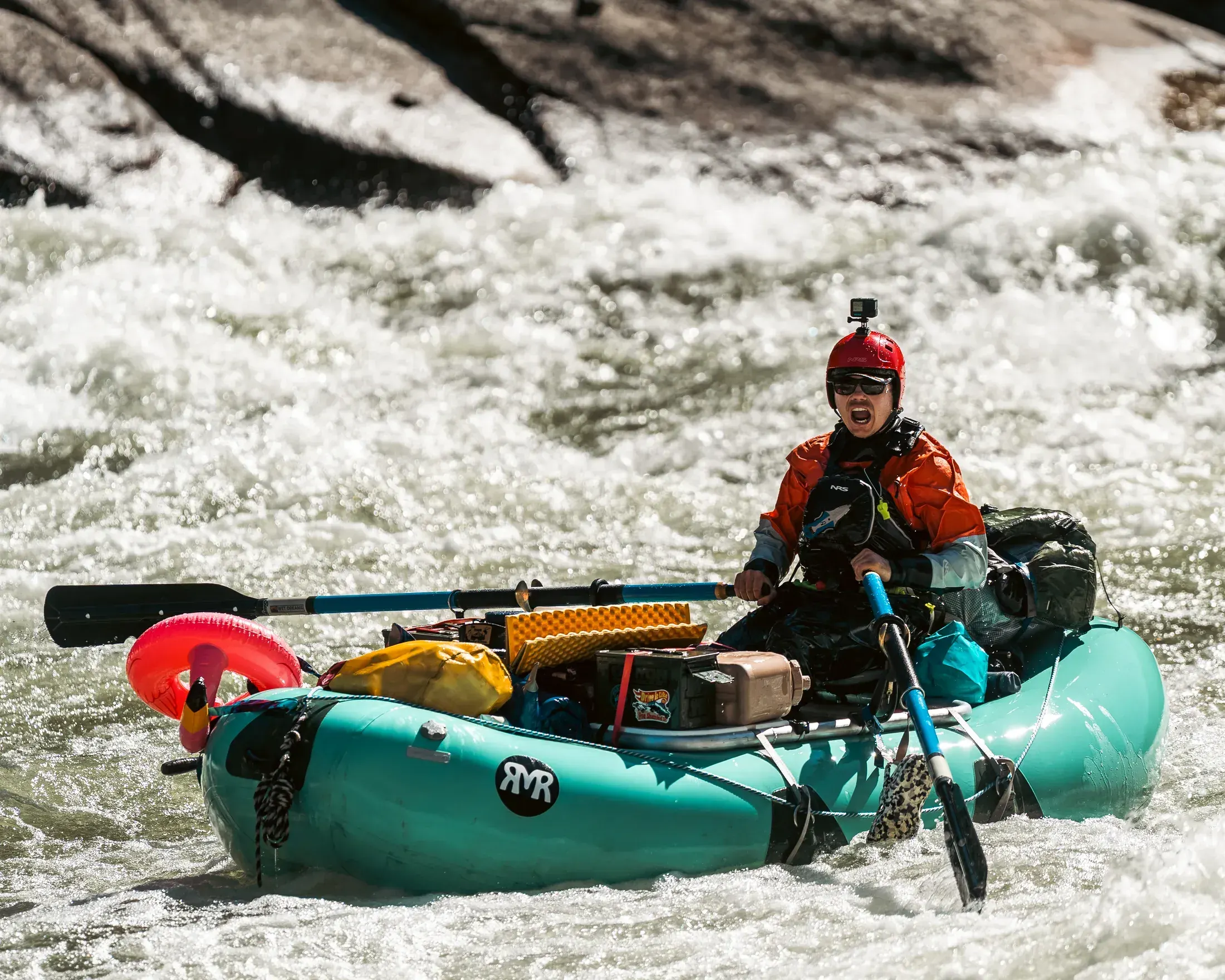 Loaded raft riding a rapid