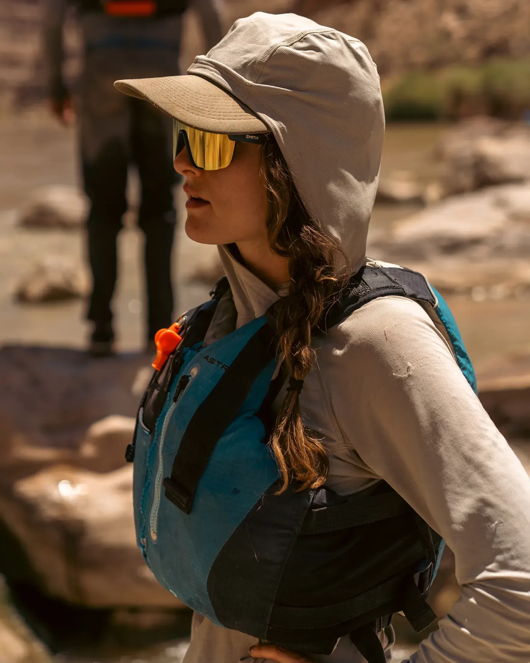 Woman in a sun hoodie and sunglasses on the river