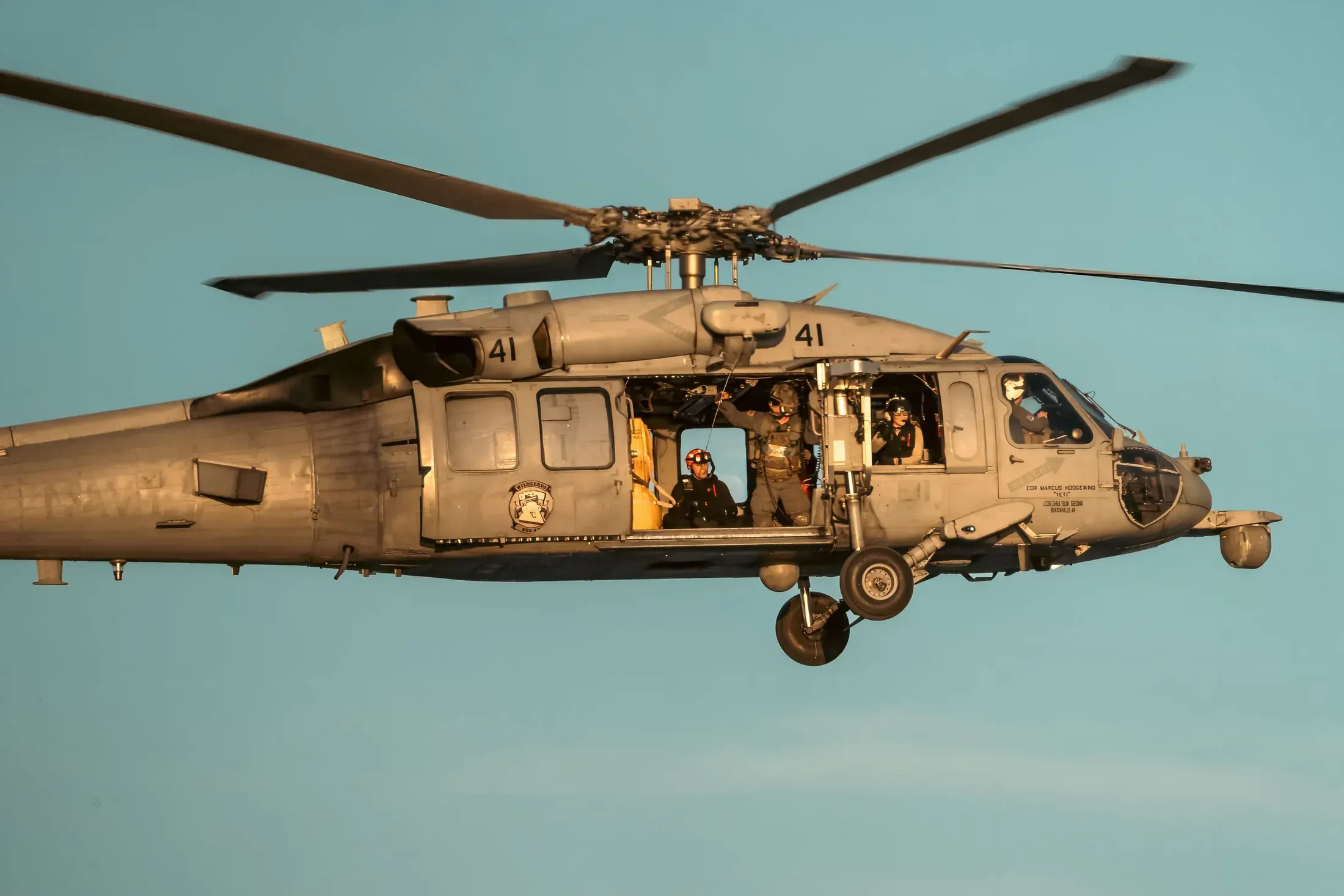 Navy helicopter flying over the water