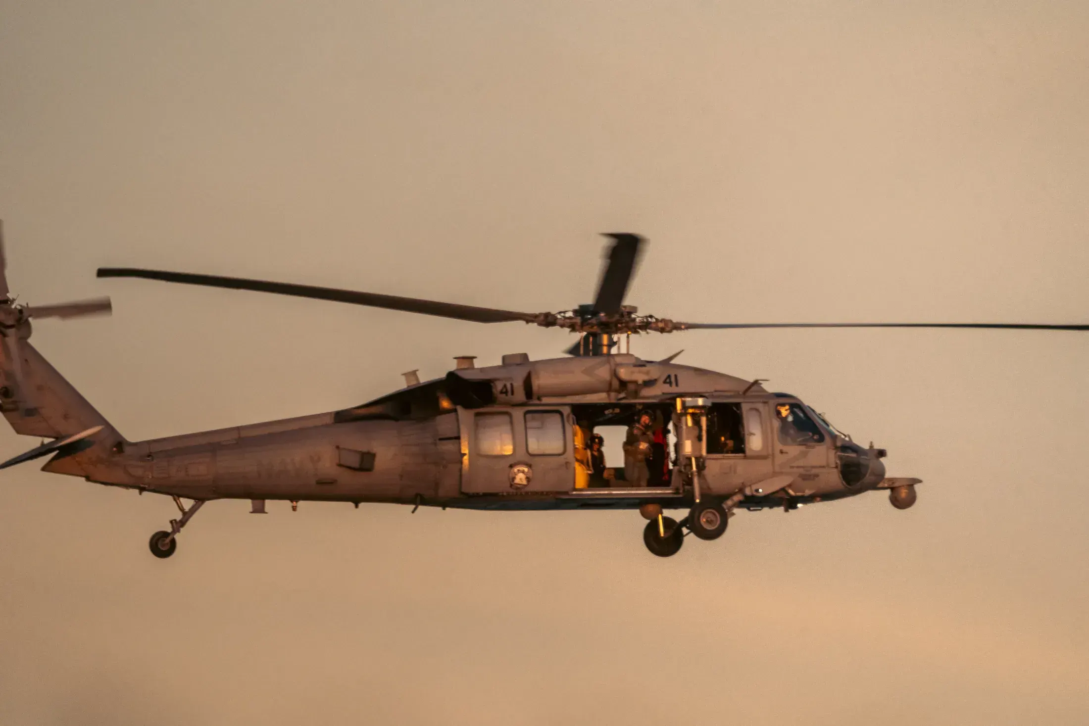 Navy helicopter in flight at dusk