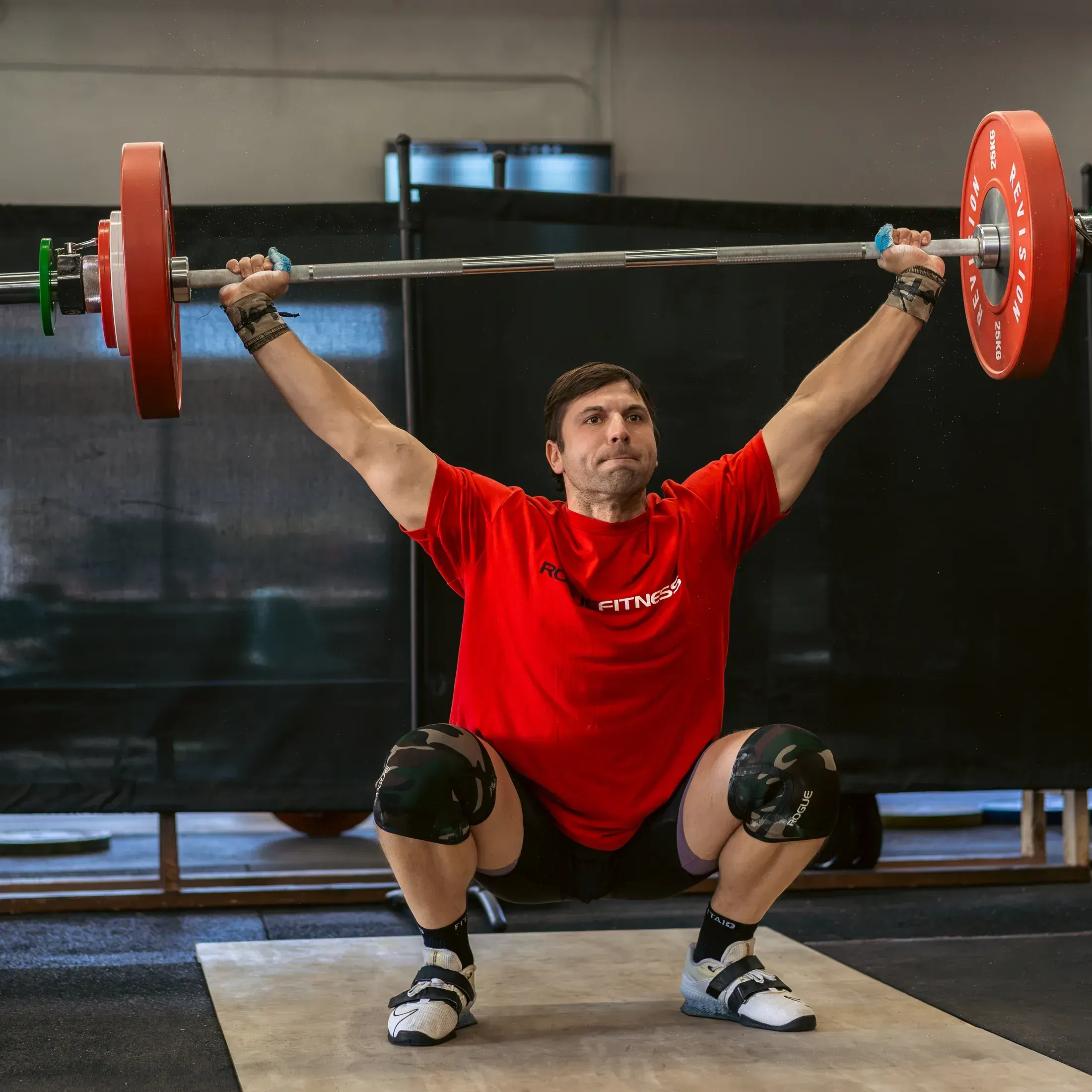 Weightlifter locking out a snatch overhead