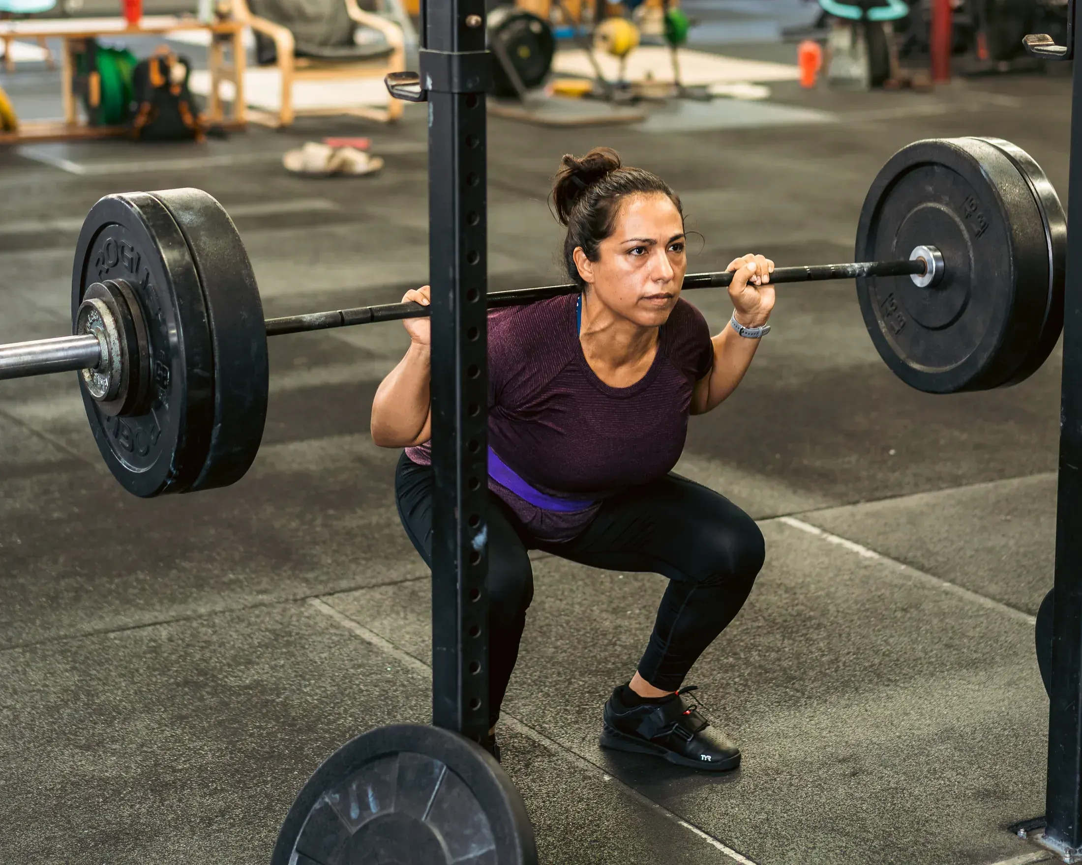 Athlete squatting in the rack