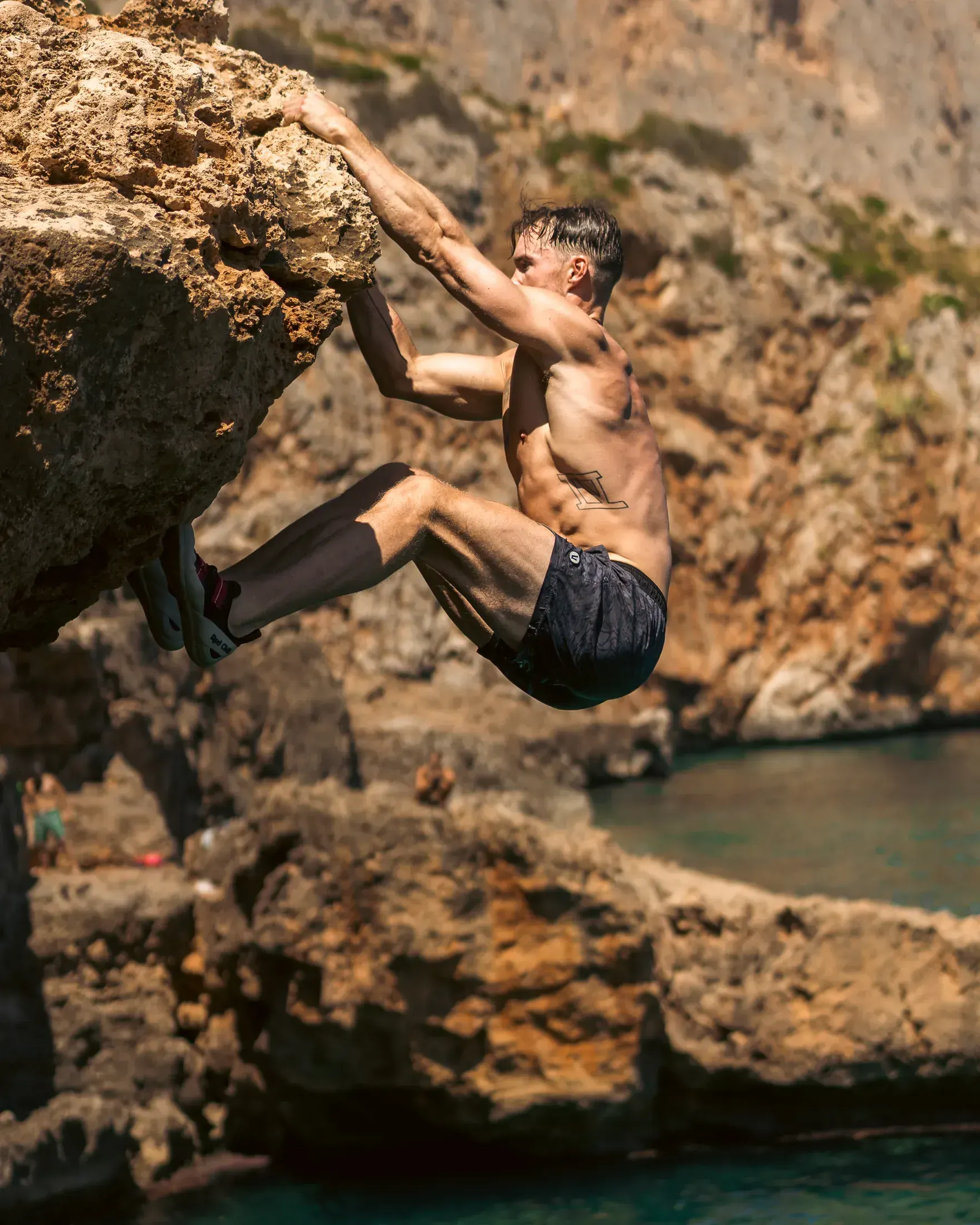 Climber pulling over a sea cliff