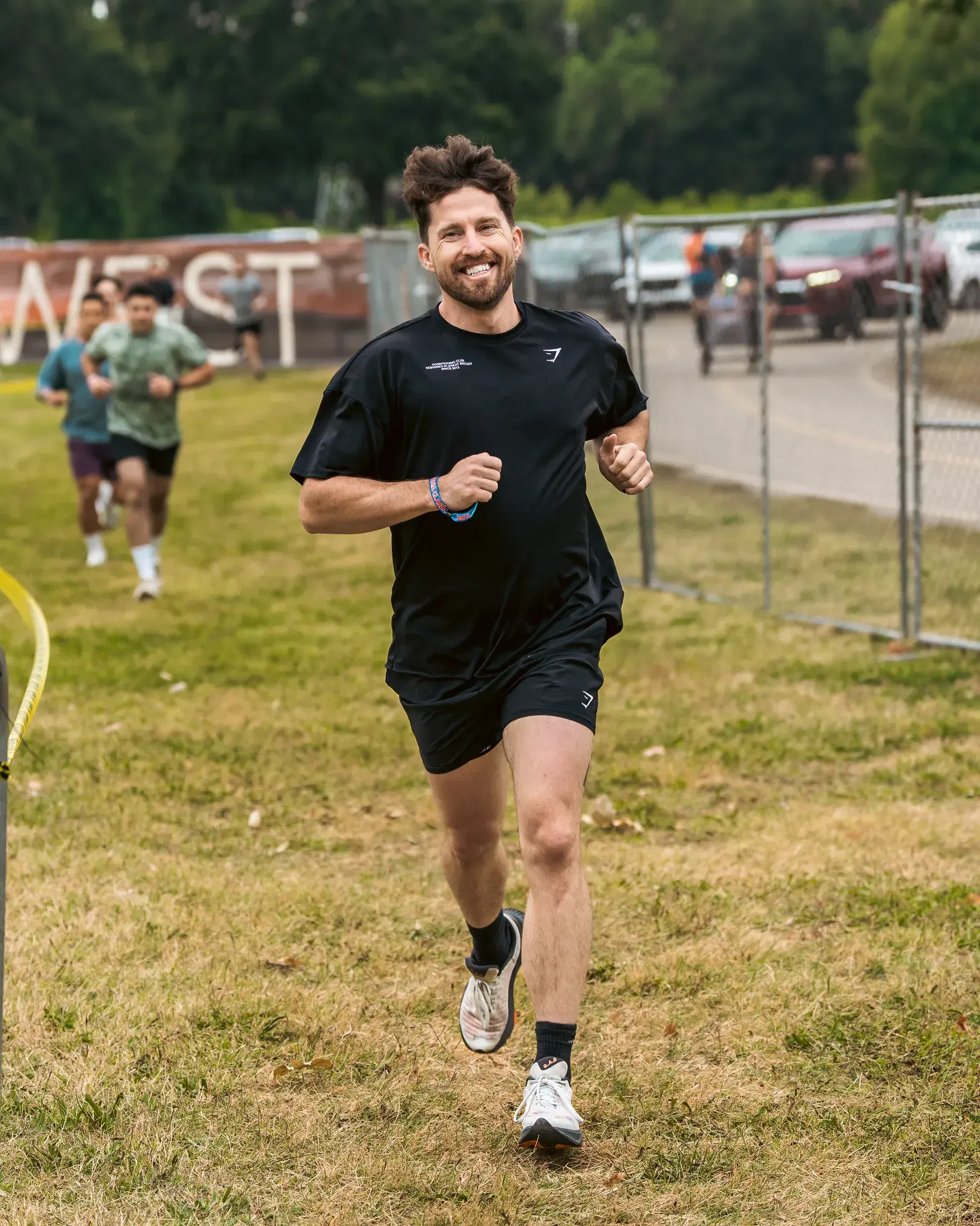 Runner smiling at the finish of a trail race