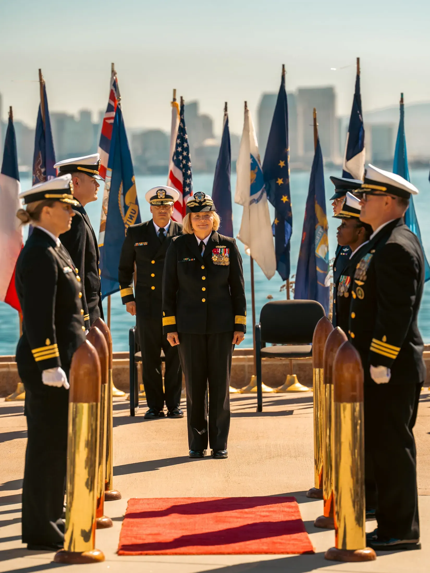 Change of command ceremony with sideboys and flags