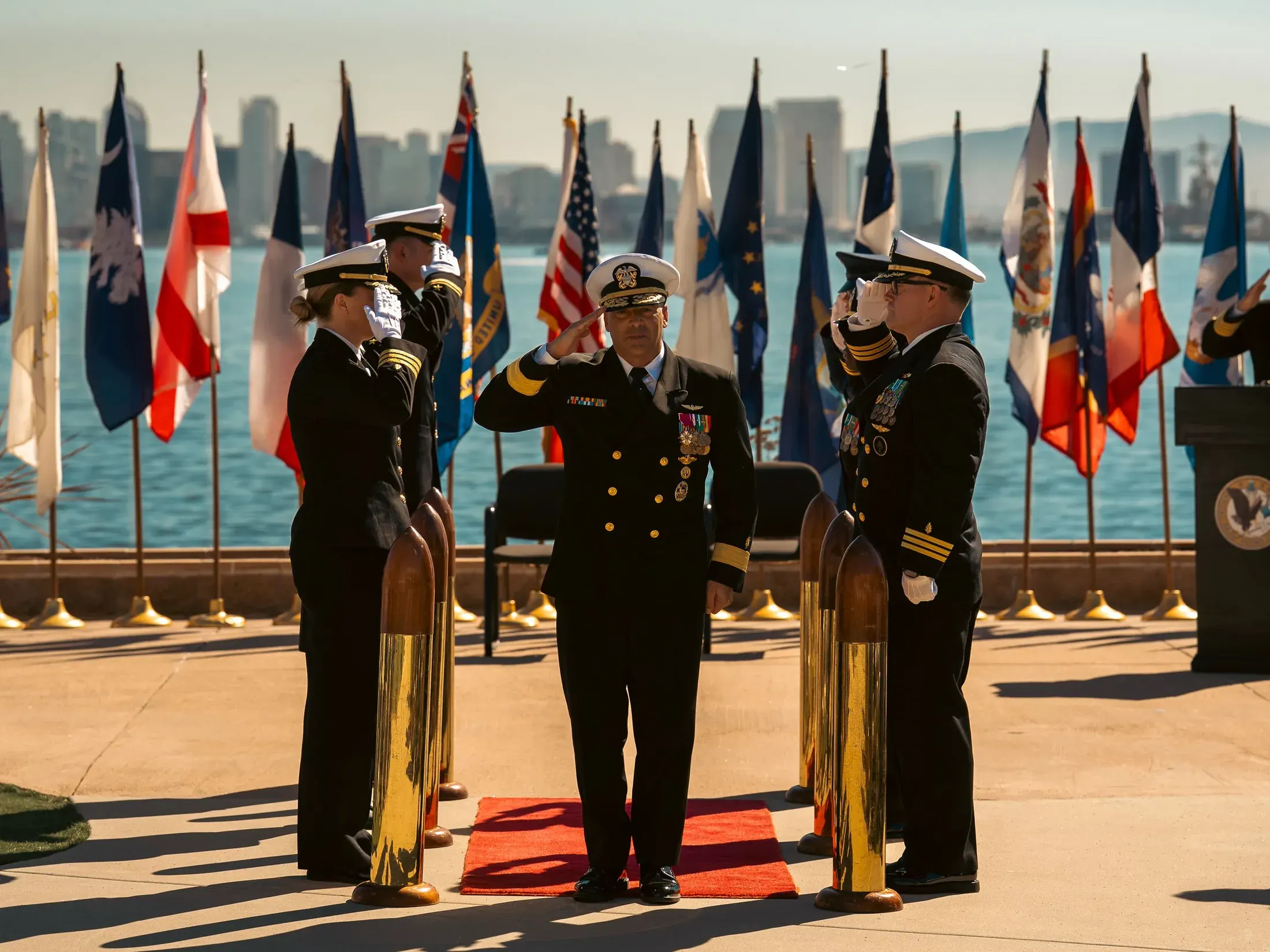 Officer saluting on a red carpet during a change of command