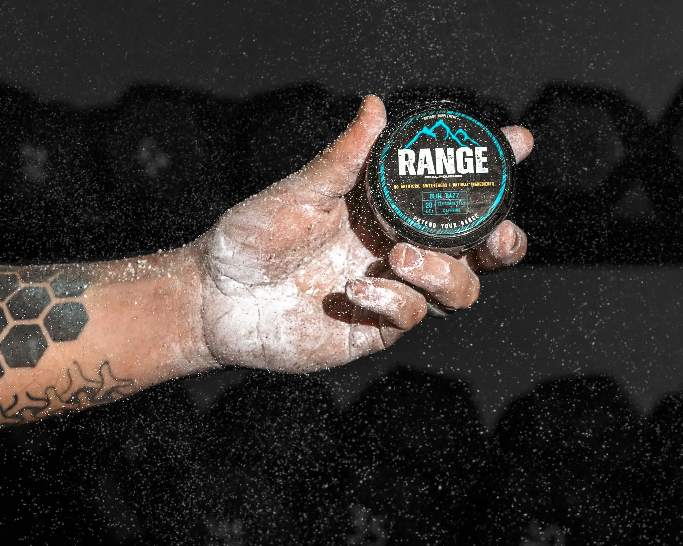Chalky hand holding a Range tin