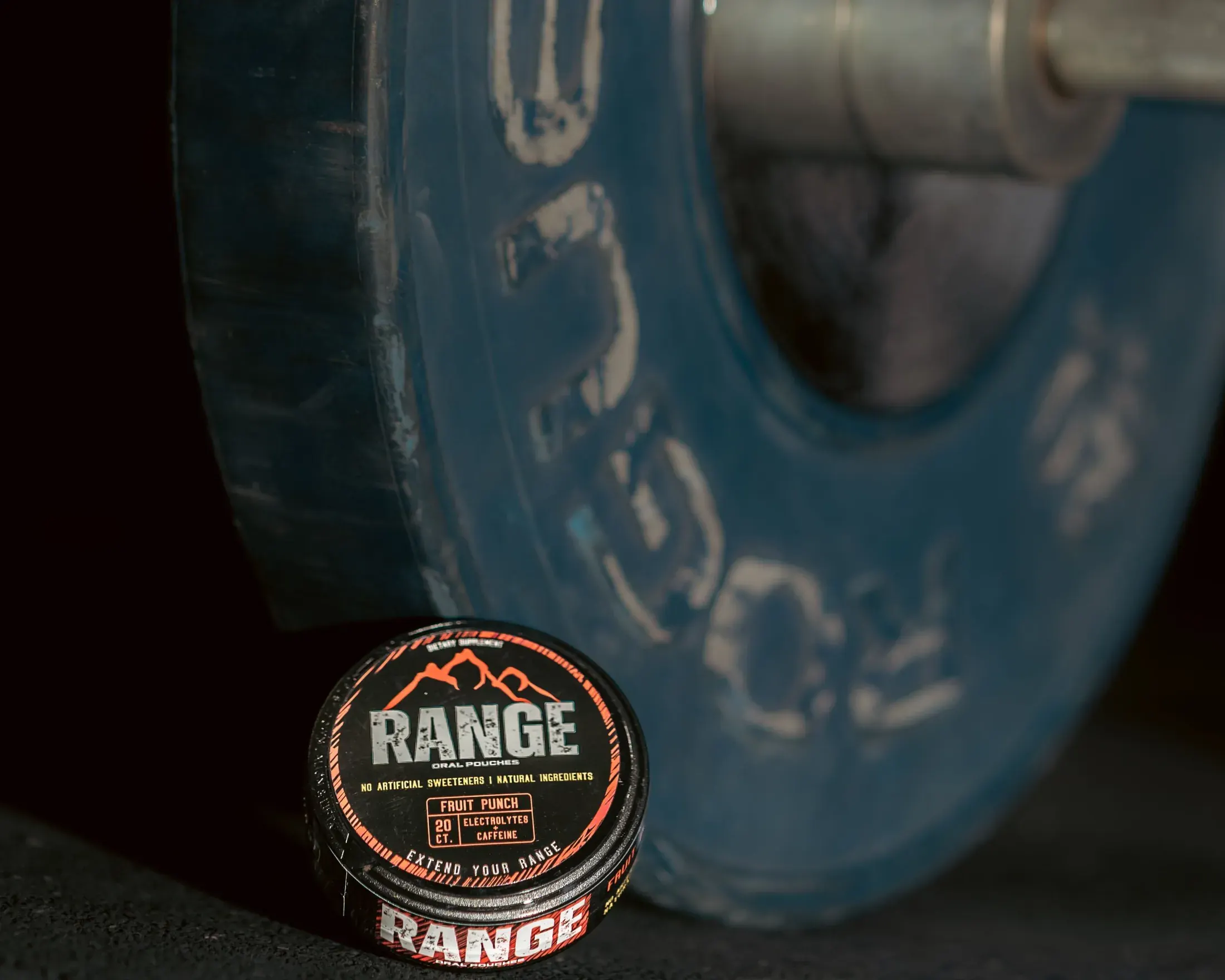 Range pouch tin resting on a weight plate