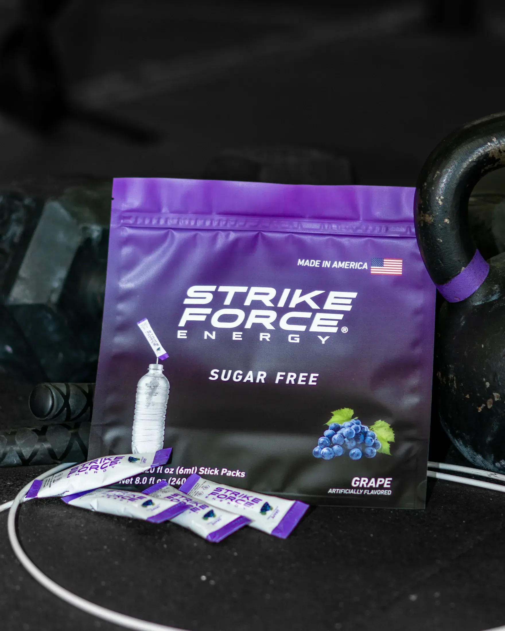 Strike Force Energy grape packets beside a kettlebell