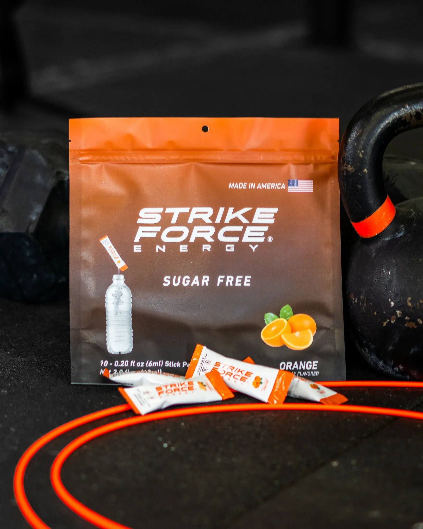 Strike Force Energy orange packets beside a kettlebell