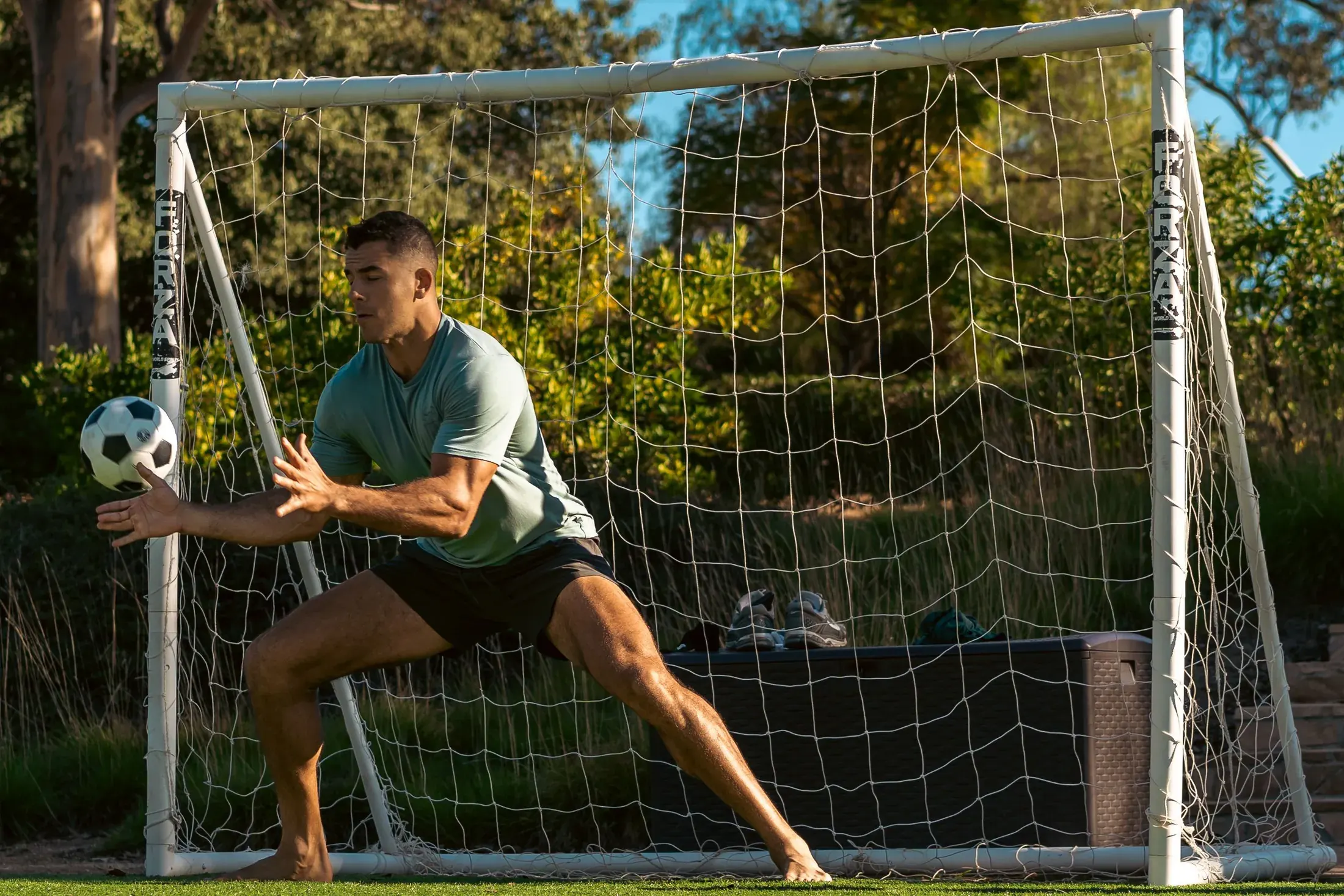 Goalkeeper diving at a backyard soccer game